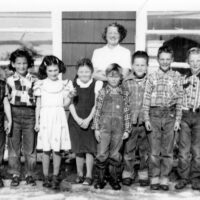 Photo of children with school teacher, black and white, circa 1951.