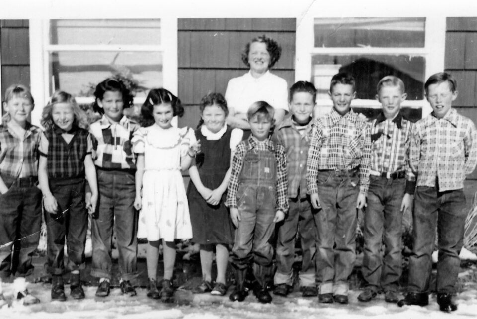 Photo of children with school teacher, black and white, circa 1951.