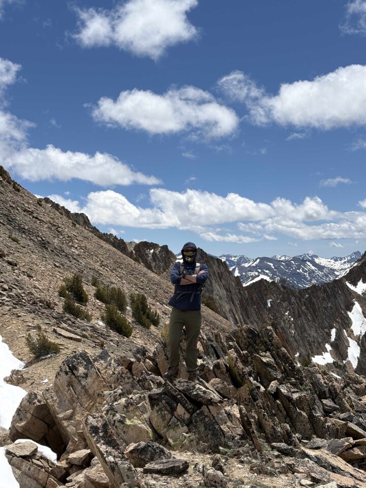 Staff standing on side of mountain up Patterson Peak in White Clouds Wilderness.