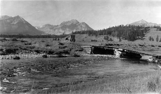 Old car over old bridge in the mountains.